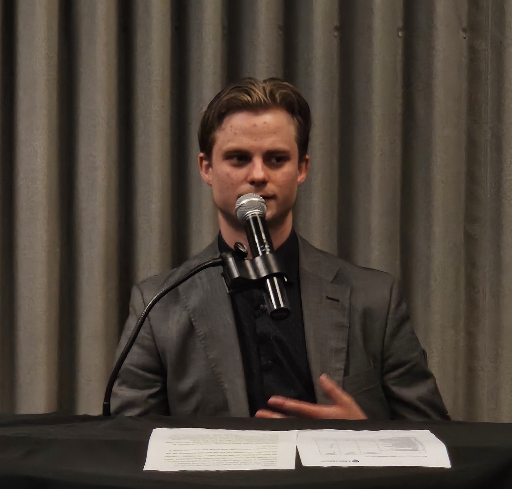 Xander Marshall speaking into a microphone